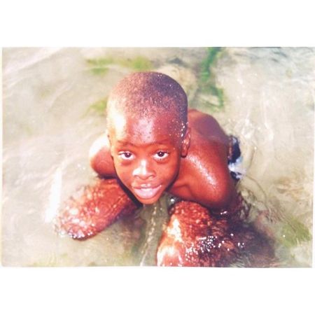 Young Winston Duke strikes a pose while swimming